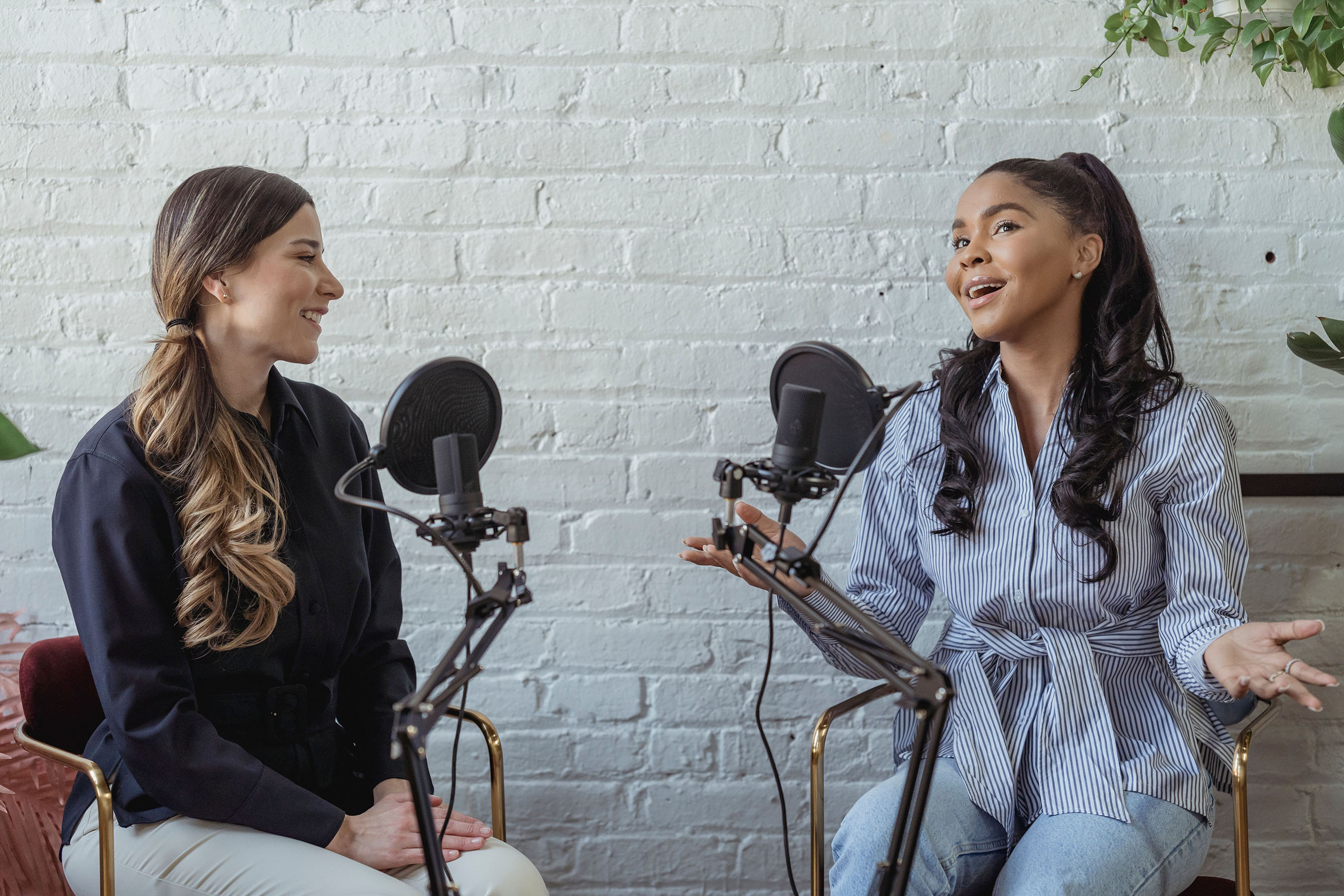 Two young women talking on radio microphones